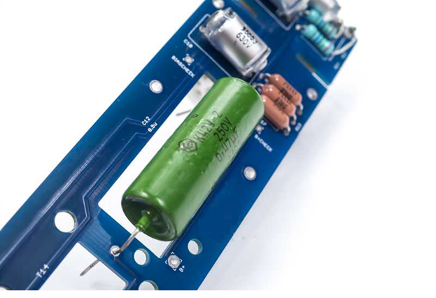 C12 output coupling capacitor installed on the D-12 PCB. Two options shown: NOS K42Y-2 PIO (0.47 µF) and polypropylene (1.0 µF).